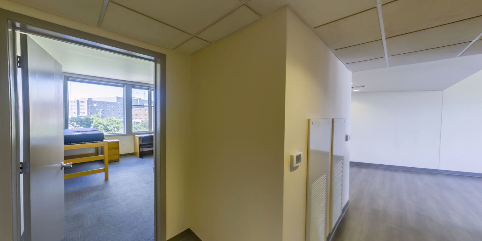 This side of the first hallway connects to a double bedroom and a common area.