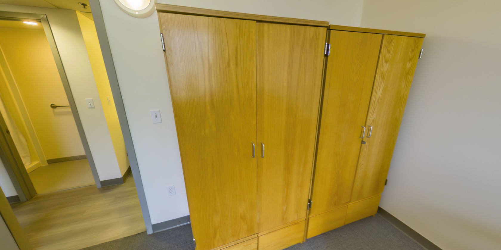 This side of the bedroom has two sets of closet storage with small latches for padlocks near the entrance.
