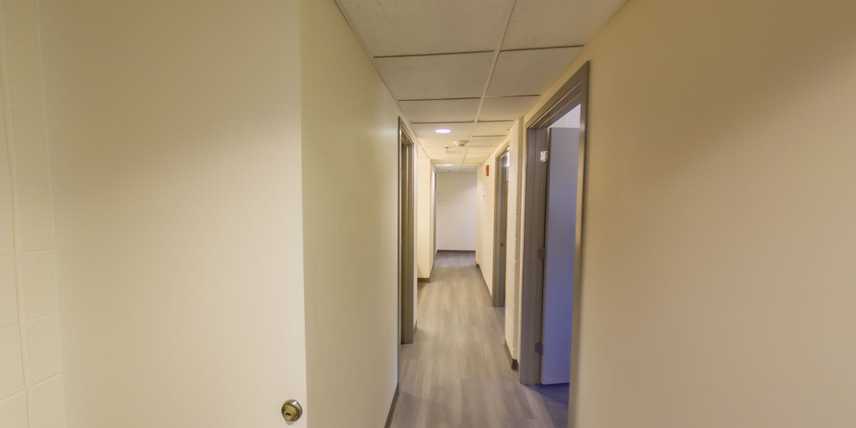 This side of the entrance has a hallway connecting to two bedrooms and a bathroom.