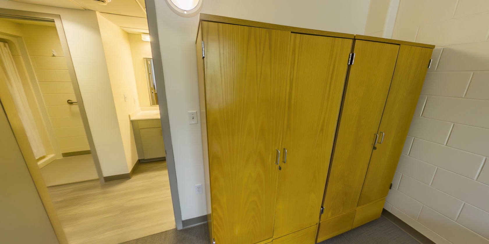 This side of the bedroom has two sets of closet storage with small latches for padlocks near the entrance.