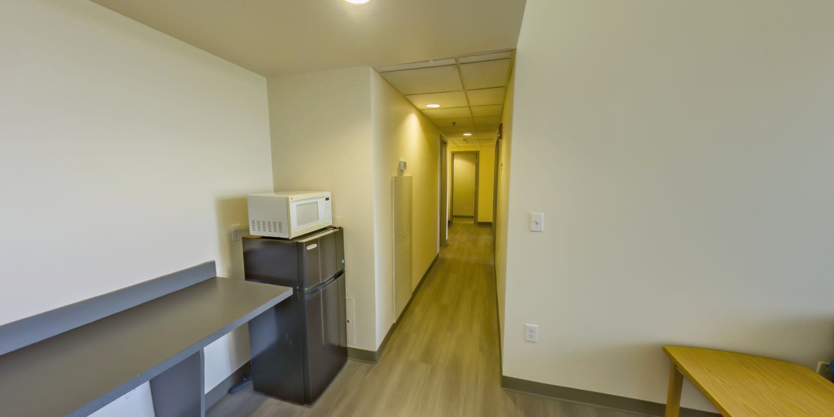 This side of the entrance leads to a hallway connecting more spaces.