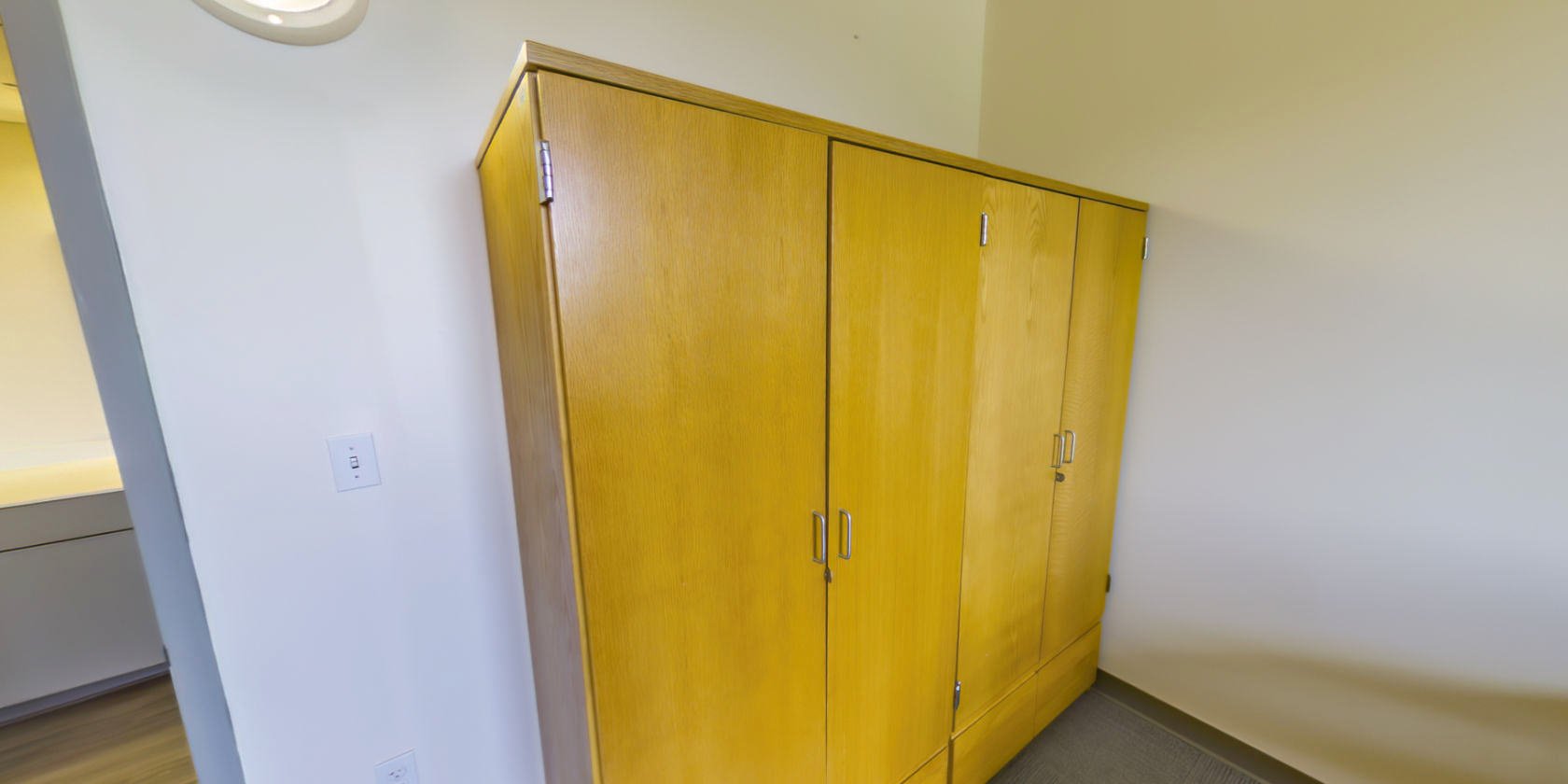This side of the bedroom has two sets of closet storage with small latches for padlocks near the entrance.